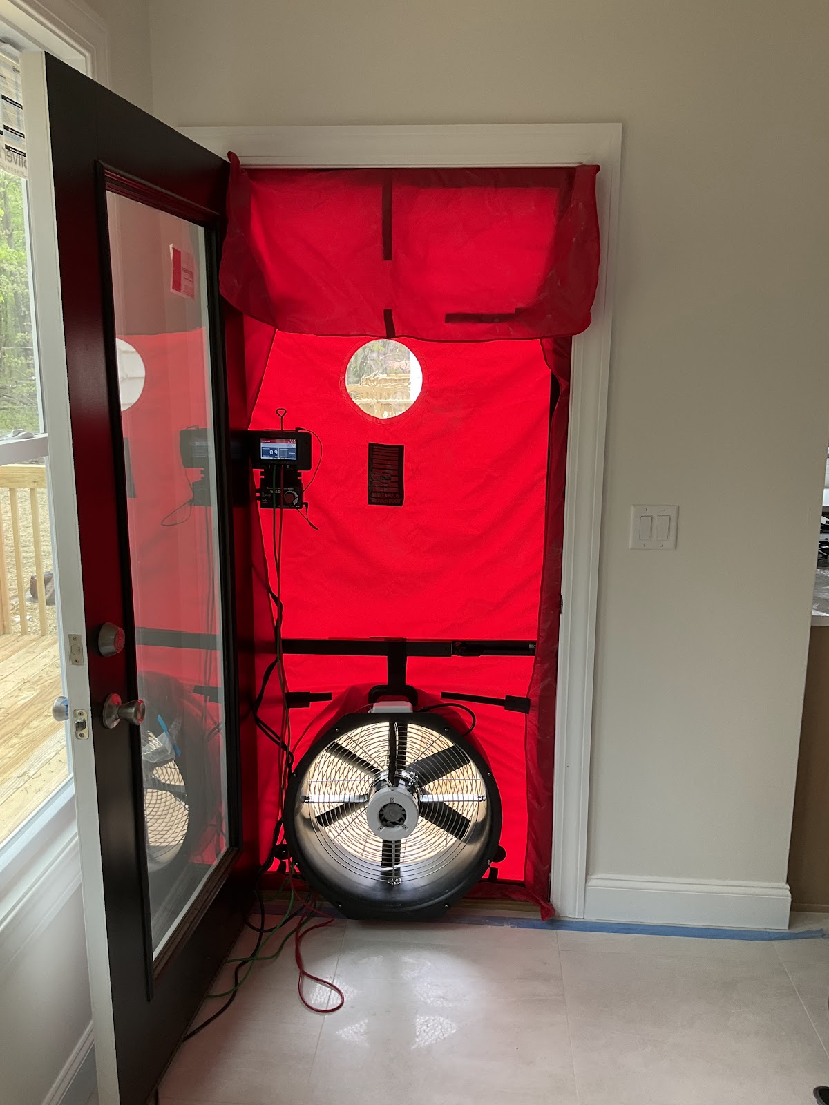 Blower door fan mounted in a doorway